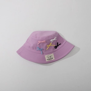 Detailed top view of purple cotton bucket hat with colorful decorative bows