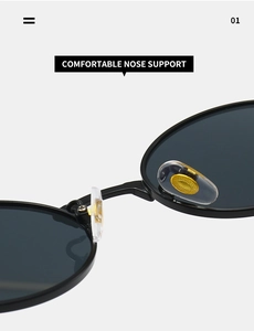 Detail of soft silicone nose pads with gold metal inserts on black oval sunglasses