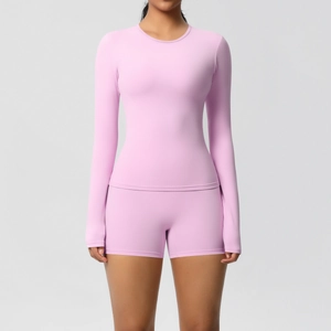 Close-up of pink long-sleeved sports top and high-waisted shorts with soft brushed fabric