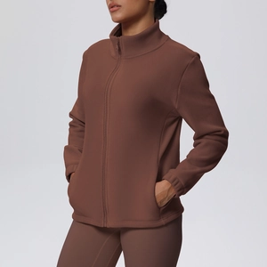 Detail of a dark brown high-neck fleece sports jacket with full-zip and side pockets