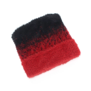 Detail of red and black gradient faux fur knit hat with thick plush texture and fold-over cuff
