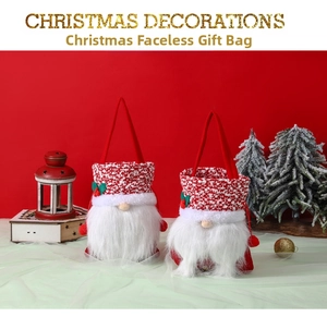 Close-up of handmade Christmas gnome gift bags with white fur and festive red knit fabric