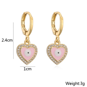 Detailed view of heart-shaped evil eye earrings with pink enamel and zircons, 2.4cm in length