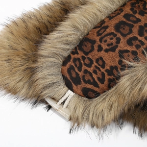 Detail of leopard print fabric and thick faux fur lining on a winter trapper hat