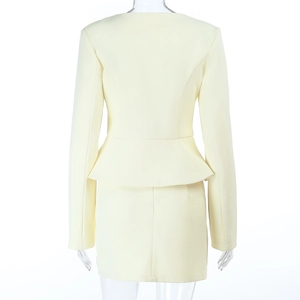 Detail of the back view of a yellow slim fit long sleeve skirt suit with waist design