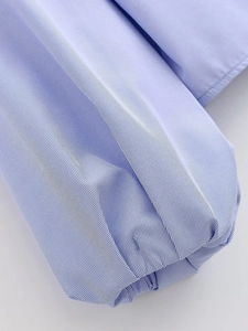 Detail of light blue striped poplin shirt showing pleated cuffs and fine stitching
