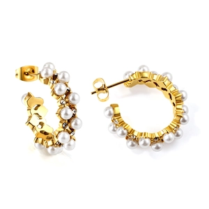 Detail view of gold C-shape hoop earrings with white faux pearls and cubic zirconia accents