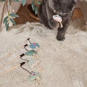Close-up of interactive cat wand toys with wooden handles and colorful plush tassels