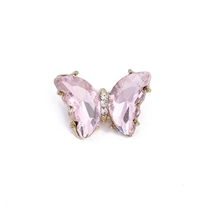 Elegant butterfly brooch with pink faceted crystals and sparkling diamonds on gold base