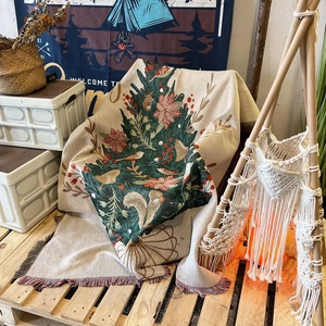 Bohemian knitted Christmas tree blanket with tassels used as a sofa throw or camping rug