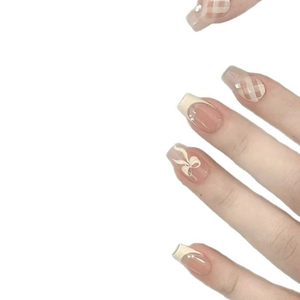 French tip press-on nails with brown plaid pattern, 3D bows, and delicate pearl rhinestones