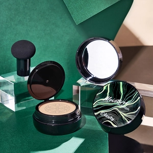Moisturizing cushion foundation set with sponge and mirror on green velvet background