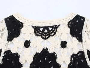 Nahaufnahme des Boho-Häkeltops mit schwarzen Blumenmustern und weißen Spitzendetails