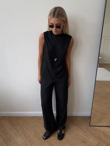 Detail of minimalist black sleeveless top and matching wide-leg pants set for women