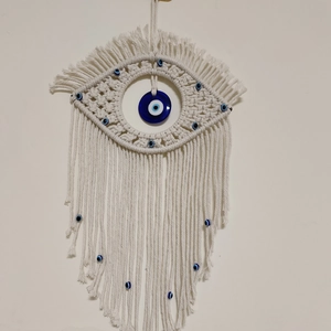 Handmade macrame evil eye wall hanging with white cotton rope and blue glass pendant