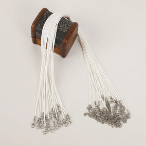 Bulk white wax cord necklaces with metal lobster clasps and extension chains on wood
