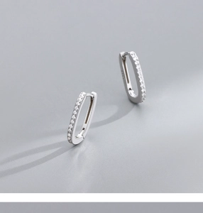 Detail of S925 sterling silver rectangular hoop earrings set with sparkling zircons