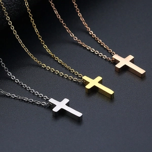 Three minimalist cross necklaces in silver, gold, and rose gold finishes with fine chains