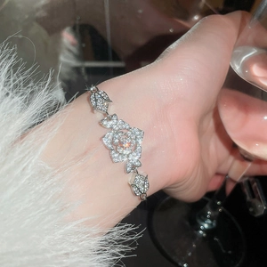 Detail of sparkling zircon flower bracelet on wrist with elegant silver finish