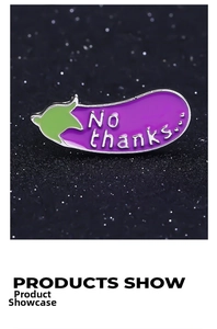 Macro view of purple eggplant enamel pin with silver No Thanks lettering and green leaf