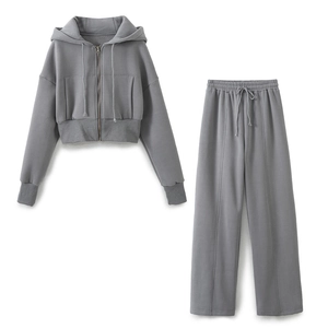 Women's grey two-piece lounge set with cropped zip hoodie and wide-leg trousers