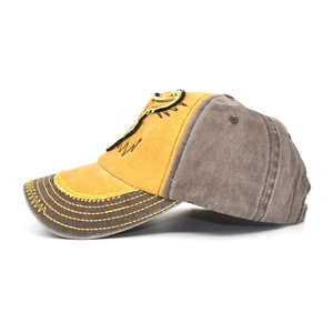 Detail of washed cotton baseball cap featuring vintage frayed edges and contrast stitching