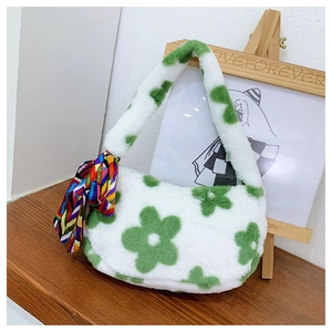 Detail of soft white plush handbag featuring a green flower and colorful silk scarf detail
