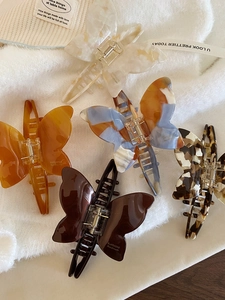 Set of five elegant acetate butterfly hair claws with marble and amber textures