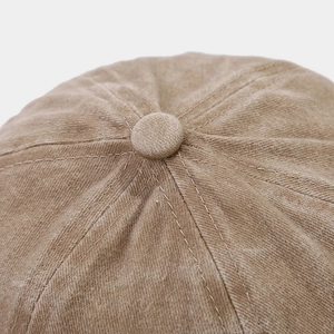 Macro shot of khaki cotton docker hat crown with reinforced stitching and top button
