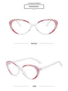Detailed view of cat eye glasses with red triangle patterns on transparent frames