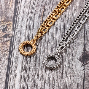 Detailed view of gold and silver stainless steel chunky chain bracelet with OT buckle clasp