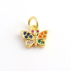 Macro shot of a golden butterfly charm with colorful zircon stones for jewelry making
