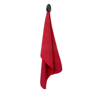 Macro shot of red waffle texture golf towel with black plastic hook attachment