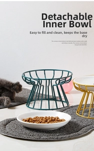 Detail view of detachable ceramic pet bowls with green and gold metal stands on a mat