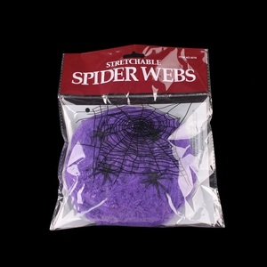 Detail view of purple stretchable spider web and black plastic spiders in packaging