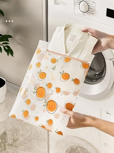 Close-up of fine mesh laundry bag with orange patterns and a shirt inside for washing