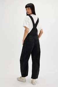 Side view of retro washed black loose-fit denim overalls with functional multi-pockets