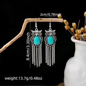 Detail view of retro owl tassel earrings with turquoise stone and dimension specs