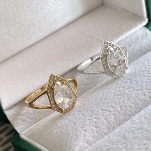 Elegant pair of S925 sterling silver rings with pear-cut halo teardrop stones in a box