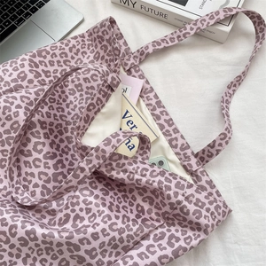 Detailed interior view of a large leopard print tote bag with smooth cream lining