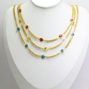 Bohemian gold layered necklace with multicolored evil eye enamel pendants on white mannequin