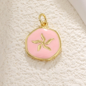 Detail of pink enamel seahorse pendant with golden starfish charm for DIY jewelry
