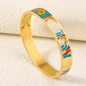 Detailed macro view of 18K gold plated stainless steel bangle with colorful enamel inlay