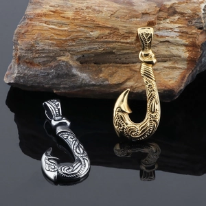Vintage steel fish hook pendants in gold and silver with intricate engraved textures