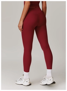 Rear view of high-waist burgundy yoga pants showing body-sculpting seams and fit