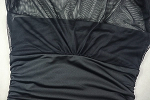 Detail of mesh splicing and ruched texture on a black slim fit sleeveless dress