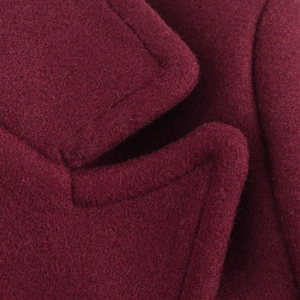 Close-up of wine red wool coat showing detailed fabric texture and premium stitching