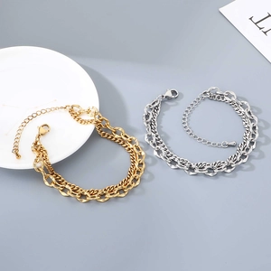 Detail of double-layer stainless steel curb and lip chain bracelet with lobster clasp