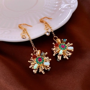 Detail shot of vintage gold flower drop earrings with multi-colored rhinestones