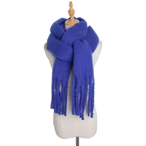 Chunky mohair blue winter scarf with fringe details worn on mannequin for warmth